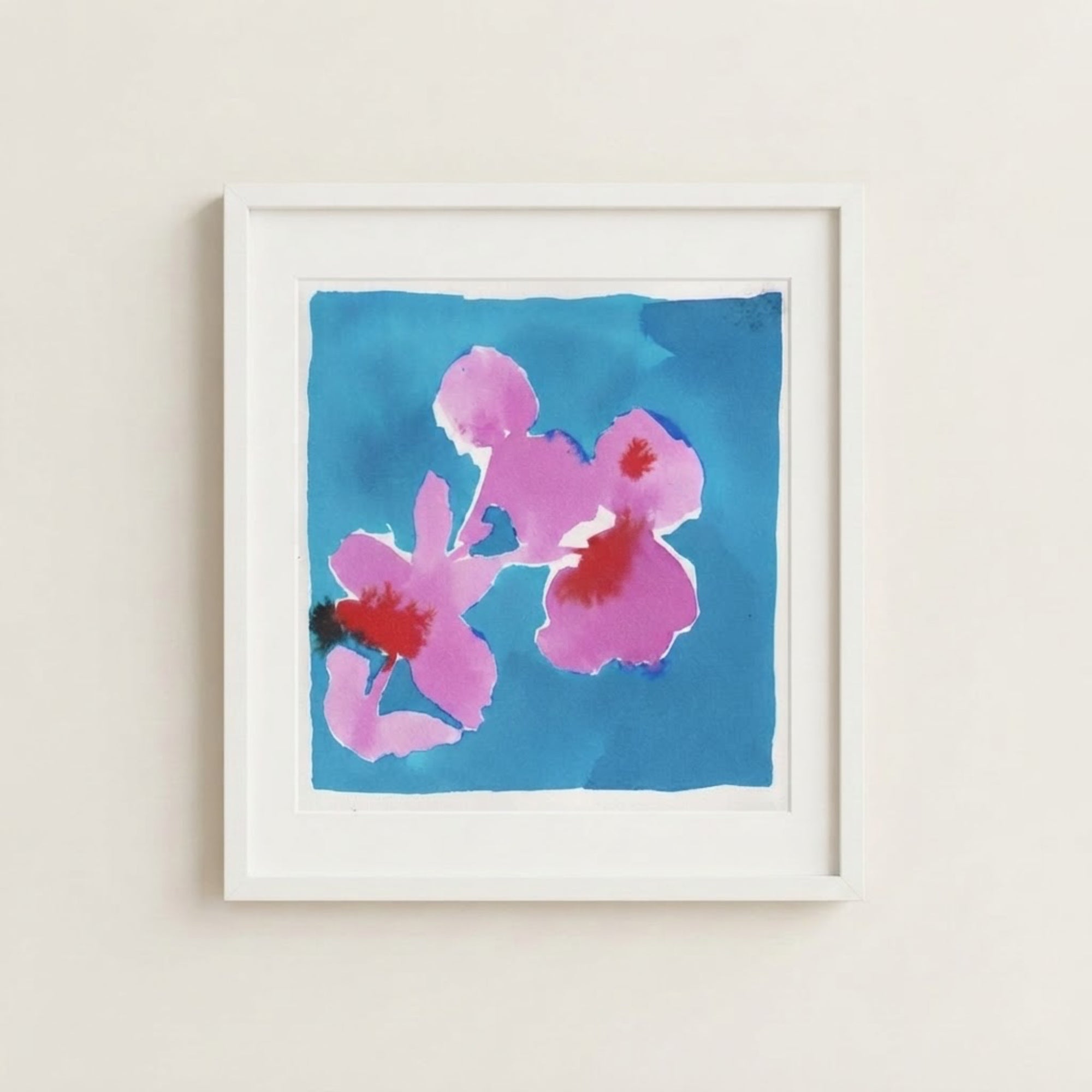 The image is a framed watercolor painting depicting a vibrant blue background with three pink flowers.