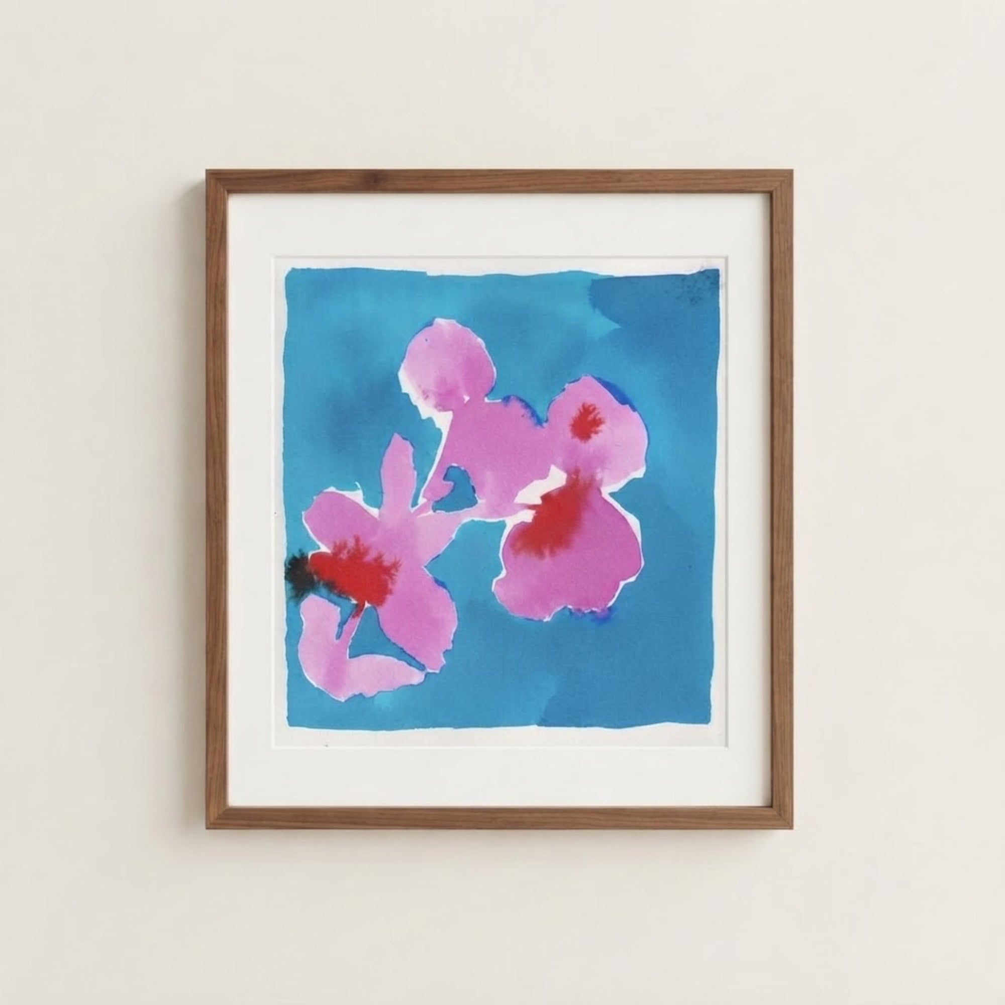 The image is a framed painting of two pink flowers against a blue background.