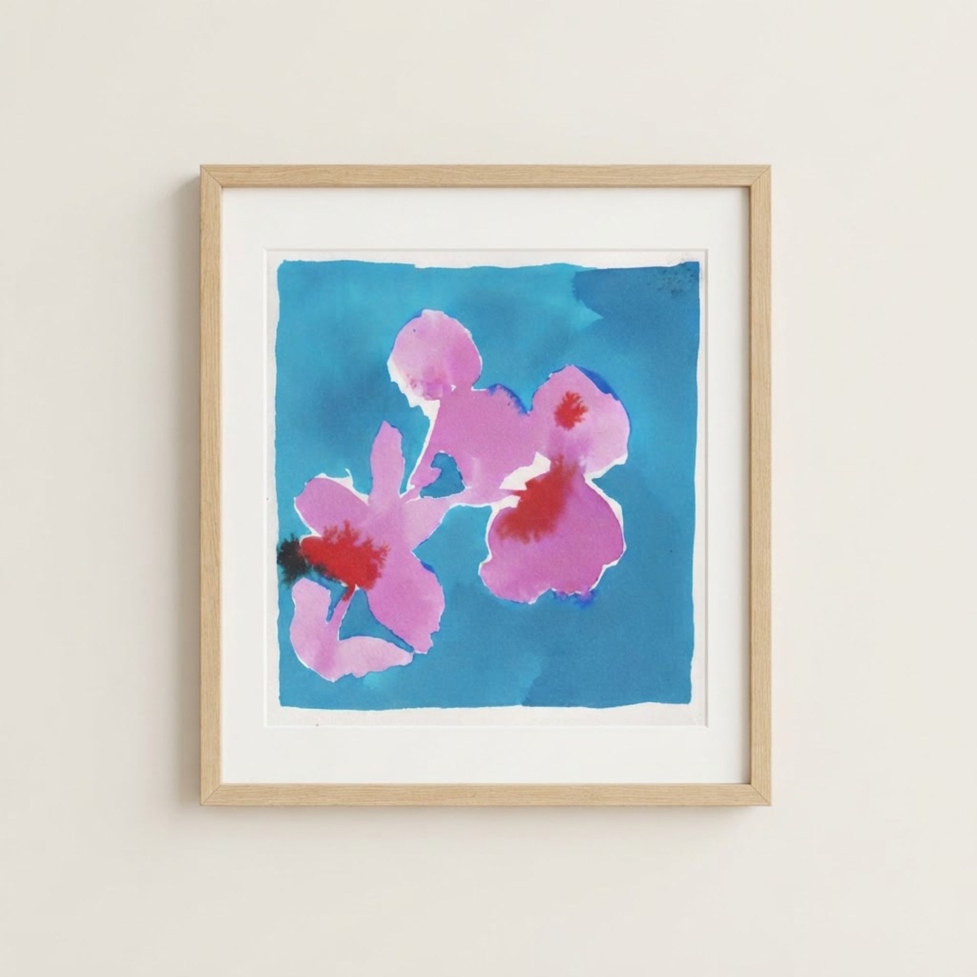 The image is a framed painting of two pink flowers against a blue background.