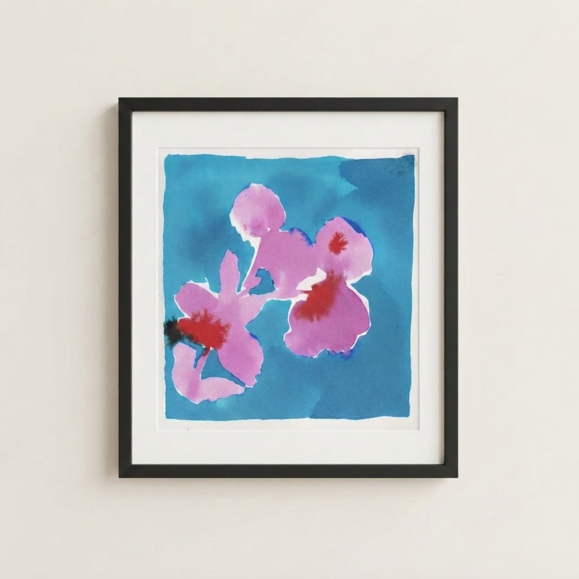 The image is a framed painting of two pink flowers against a blue background.