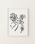 The image is a framed black and white illustration of a stylized floral design.